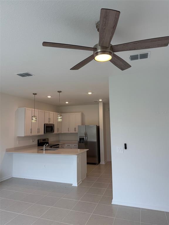 2691 Skyline Loop Kissimmee, FL 34758 - Photo 14 of 27 a view of kitchen with refrigerator and window