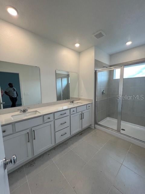 2691 Skyline Loop Kissimmee, FL 34758 - Photo 22 of 27 a bathroom with double sink and a mirror