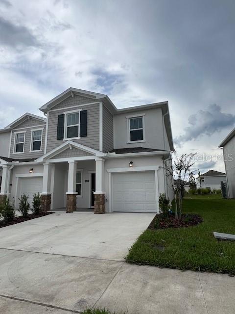 2691 Skyline Loop Kissimmee, FL 34758 - Photo 3 of 27 a view of a white house with a yard and plants