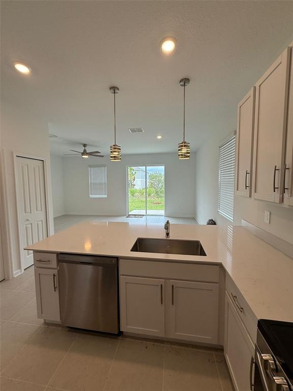 2691 Skyline Loop Kissimmee, FL 34758 - Photo 9 of 27 a kitchen with a sink and a refrigerator