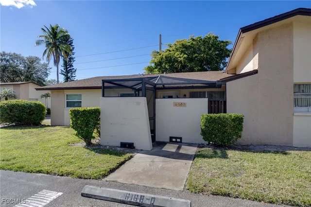front view of a house with potted plants