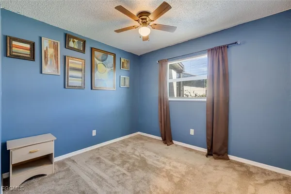 a bedroom with a bed and a ceiling fan