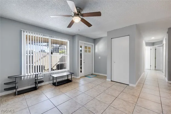a kitchen with a dining table chairs and refrigerator