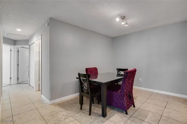 a kitchen with a sink a microwave a refrigerator and cabinets