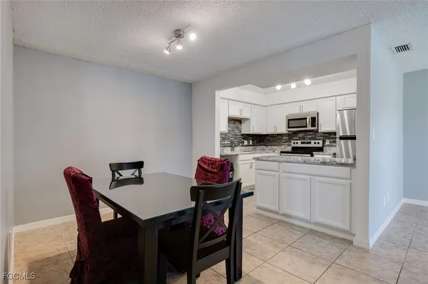an empty room with windows and ceiling fan