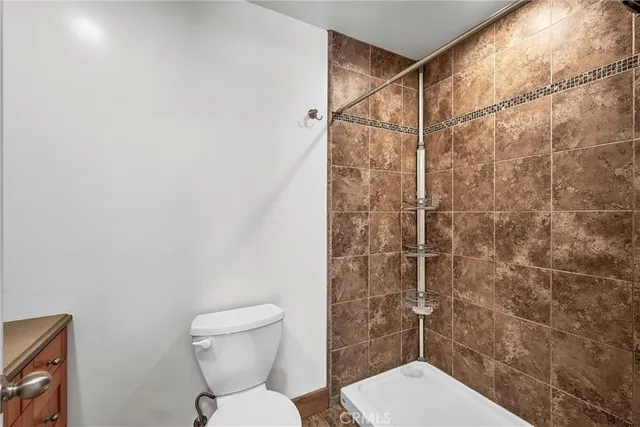 a bathroom with a toilet and a shower