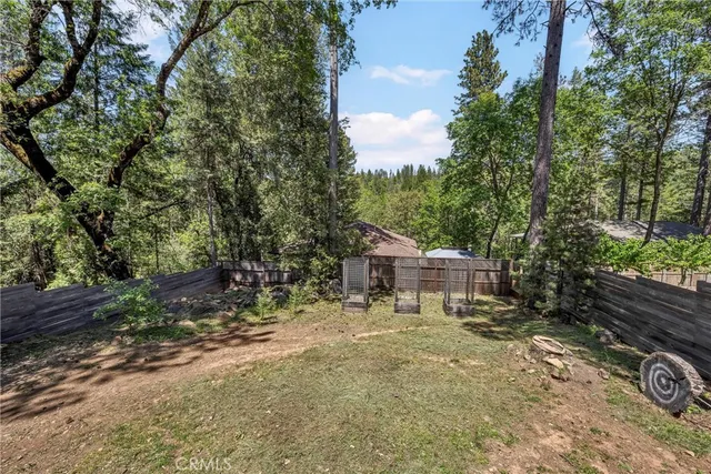 a view of a house with a yard and sitting area
