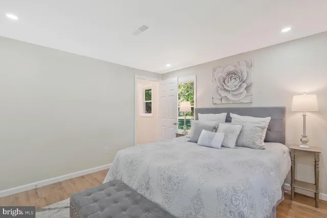 a bedroom with a large bed and a window