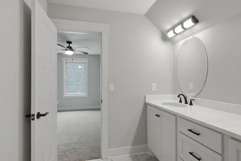 a bathroom with a sink a light fixture and a mirror
