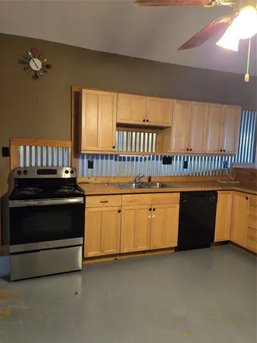 a kitchen with stove and cabinets