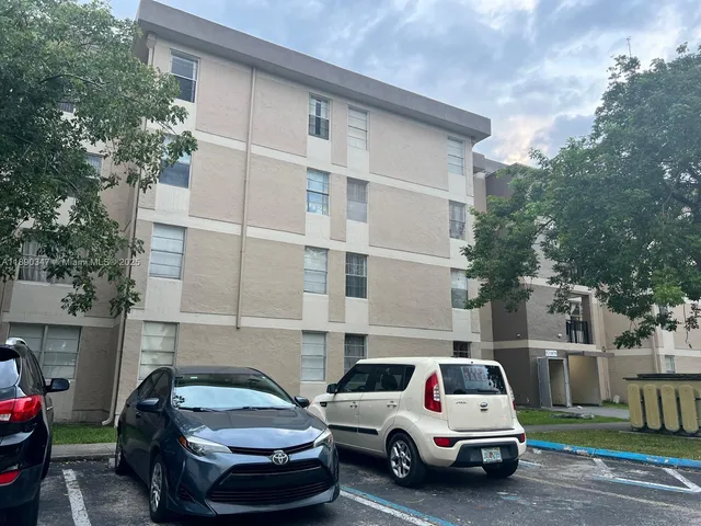 a view of a car parked in front of a house