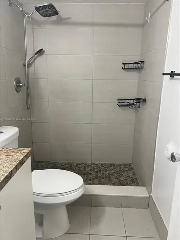 a bathroom with a toilet and a shower