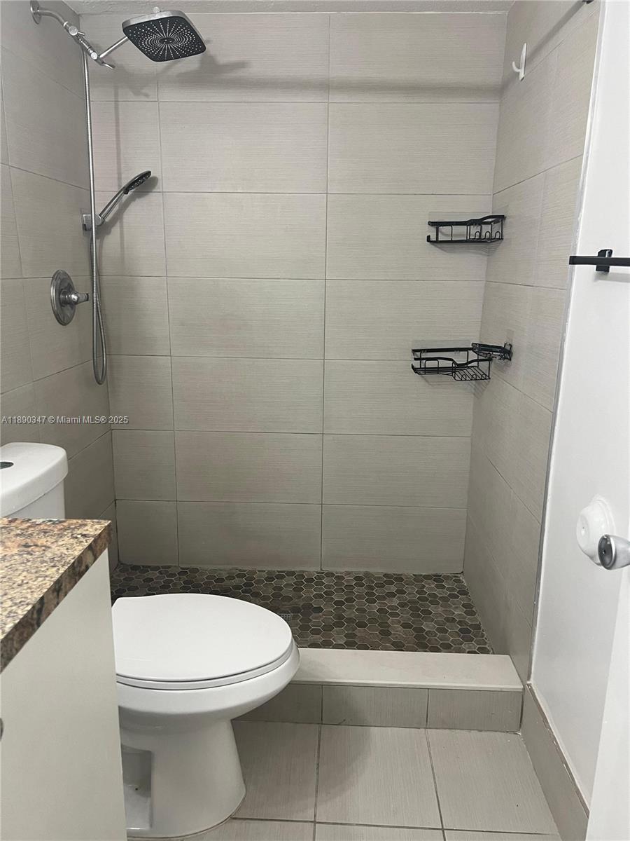 1875 West 56th Street, Unit 103 Hialeah, FL 33012 - Photo 11 of 13 a bathroom with a toilet and a shower