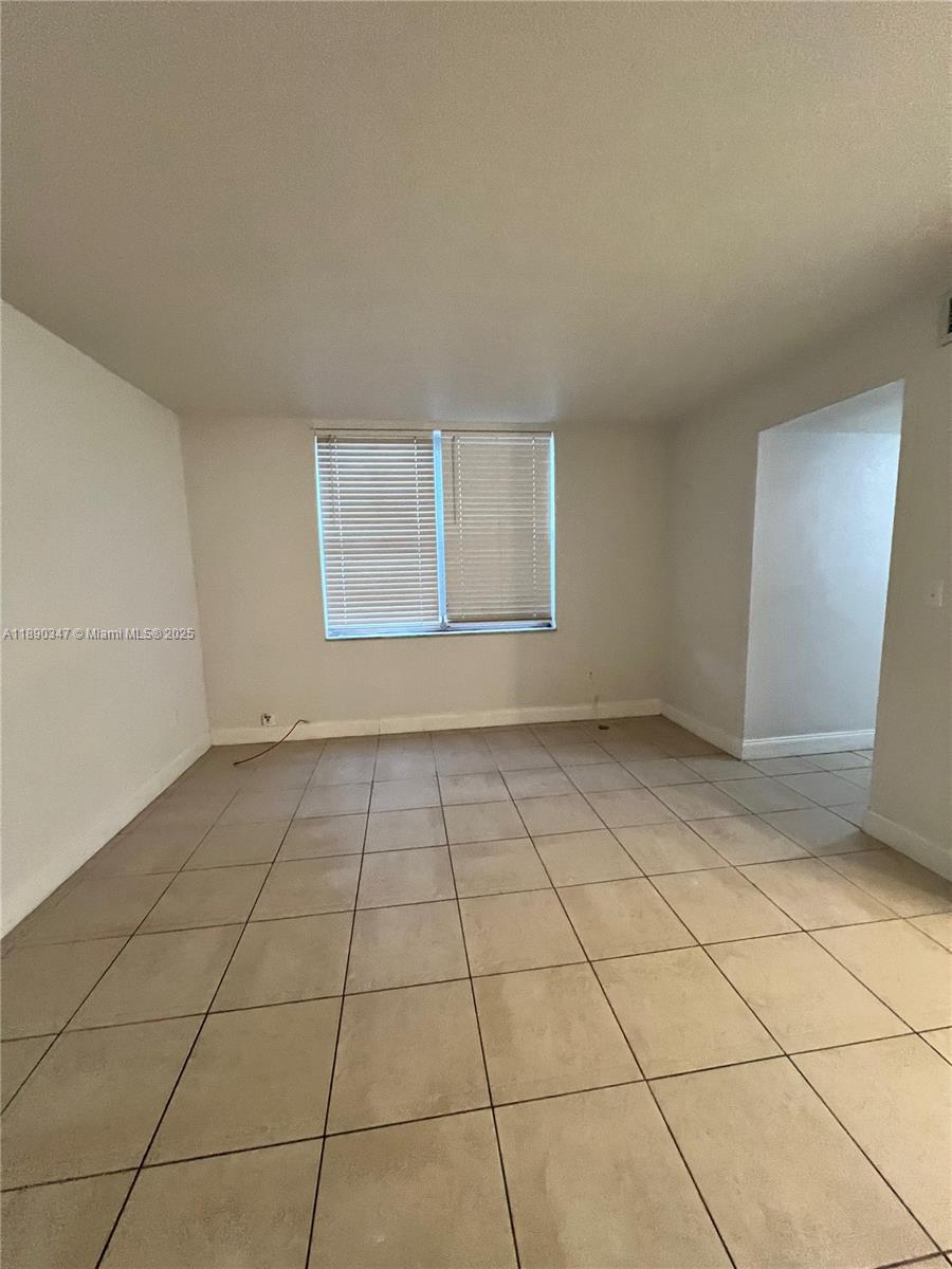 1875 West 56th Street, Unit 103 Hialeah, FL 33012 - Photo 2 of 13 a view of an empty room and window