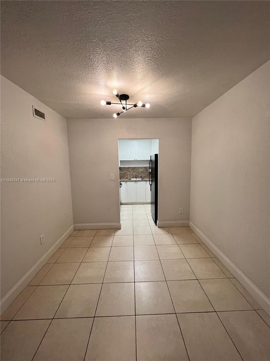 1875 West 56th Street, Unit 103 Hialeah, FL 33012 - Photo 3 of 13 a view of an empty room with a window