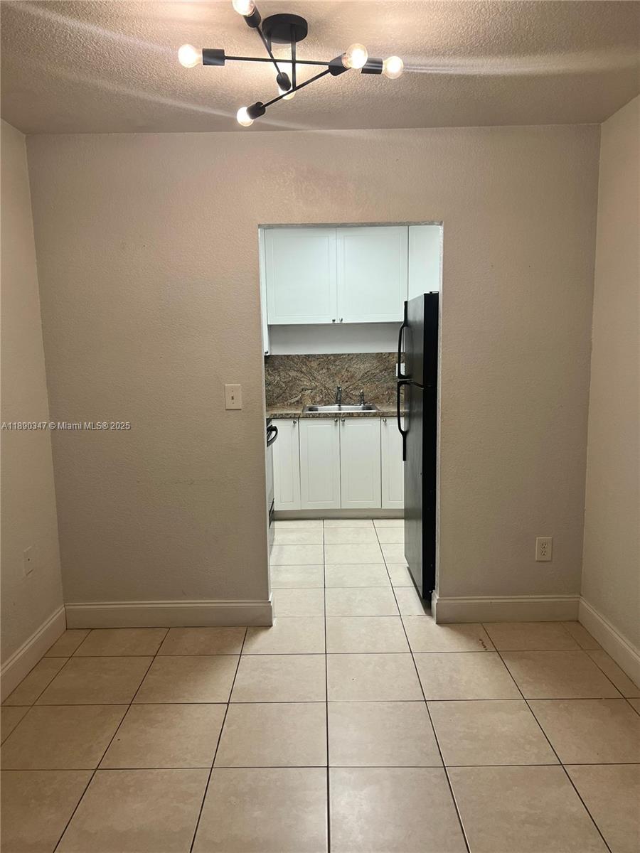 1875 West 56th Street, Unit 103 Hialeah, FL 33012 - Photo 4 of 13 a view of an empty room with a window