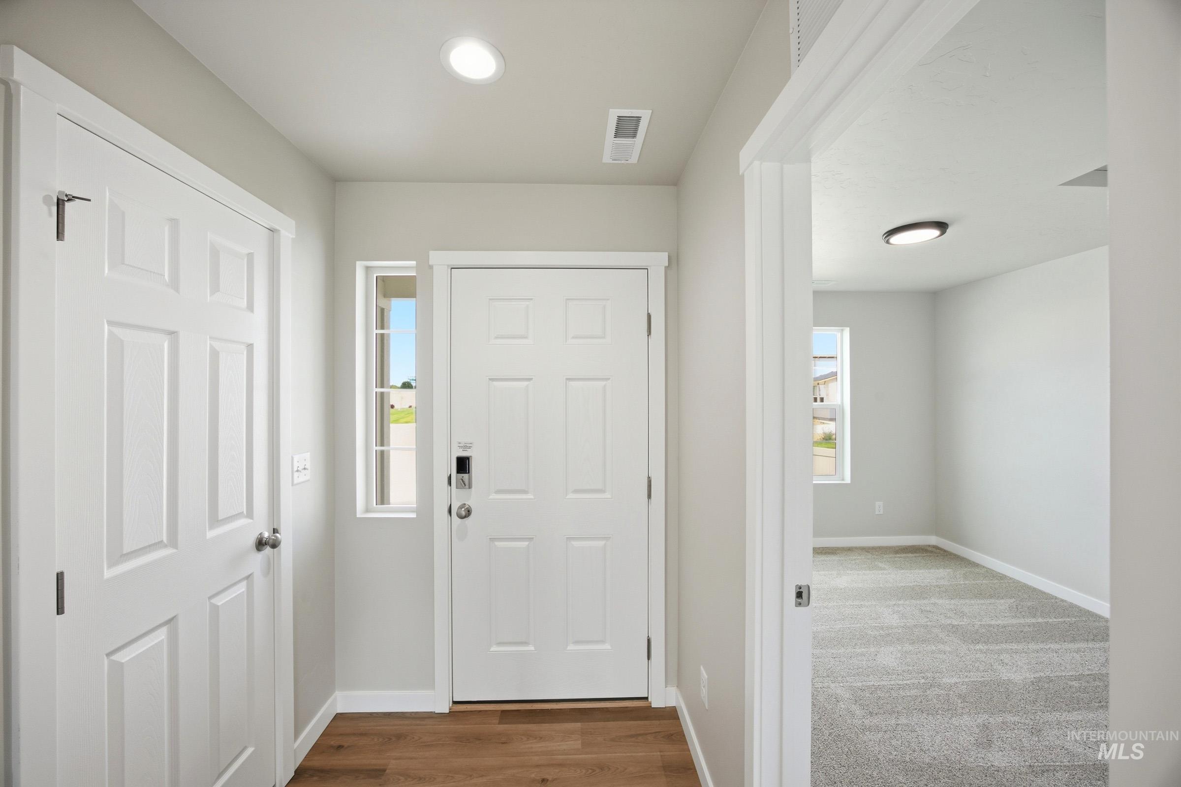 14044 Shiny Spruce Street Caldwell, ID 83607 - Photo 2 of 24 Entryway featuring wood-finish flooring, recessed lighting, and a white paneled door with a sidelight window