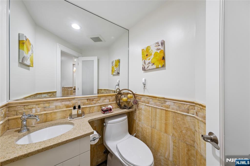 93 Jackson Drive Cresskill, NJ 07626 - Photo 13 of 37 a bathroom with a sink mirror vanity and toilet
