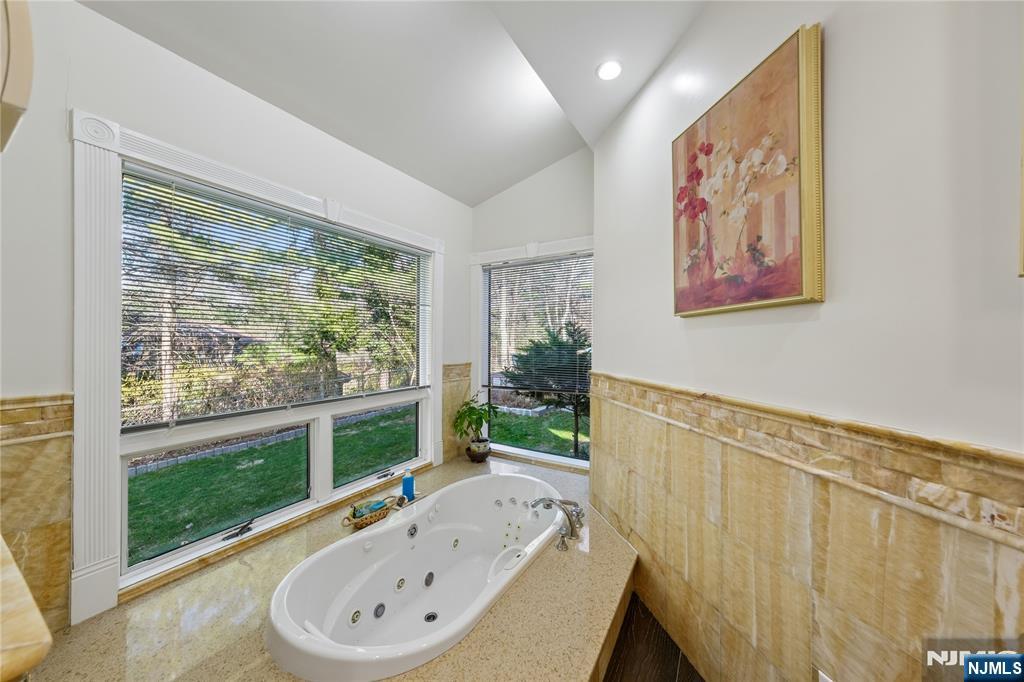 93 Jackson Drive Cresskill, NJ 07626 - Photo 14 of 37 a bathroom with a bathtub and a large window
