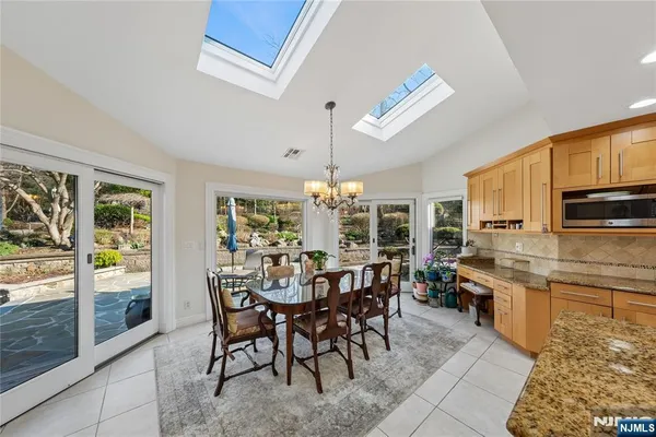 a bathroom with a granite countertop toilet sink and mirror