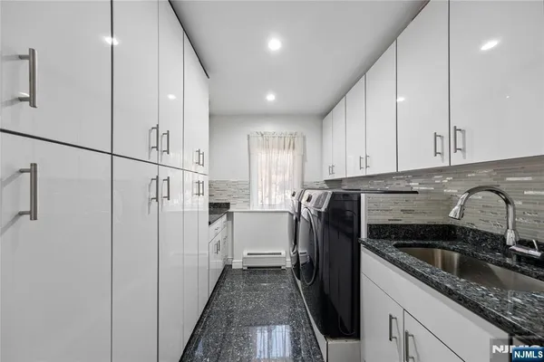 a bedroom with furniture and a large window