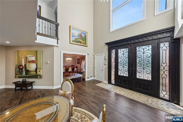 a hallway with wooden floors stairs and furniture
