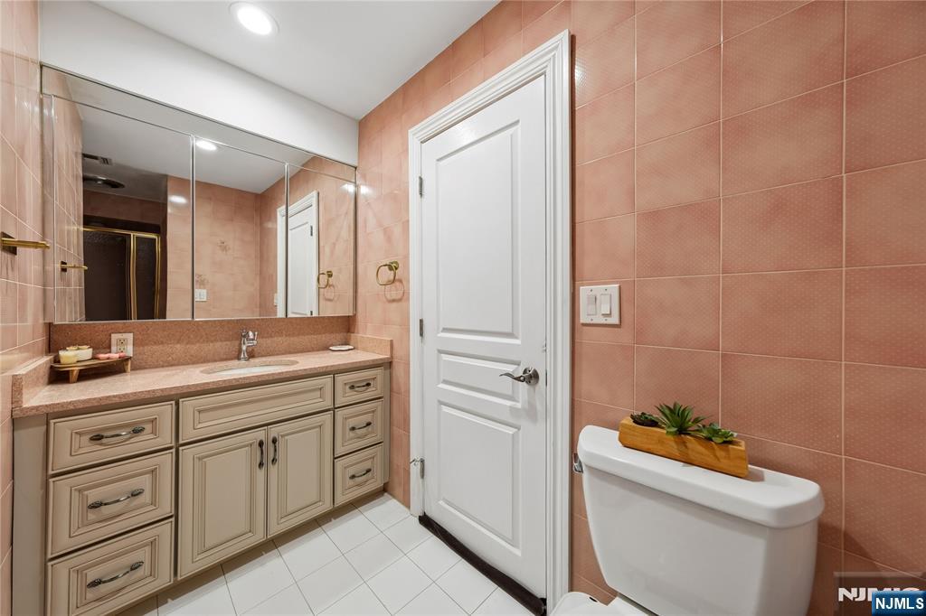 93 Jackson Drive Cresskill, NJ 07626 - Photo 24 of 37 a bathroom with a granite countertop toilet sink and mirror