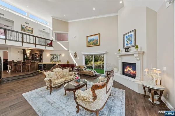 a living room with furniture a fireplace and a window