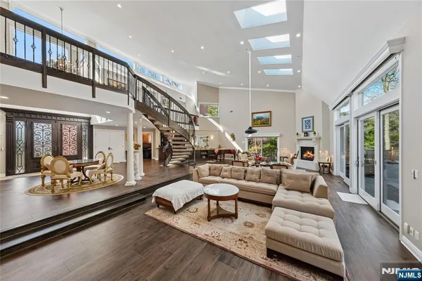 a large white kitchen with granite countertop a stove and white cabinets