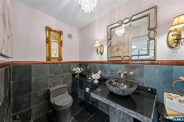 a bathroom with a sink mirror vanity and toilet