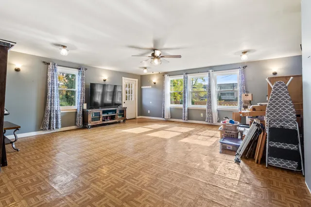 a living room with furniture and large windows