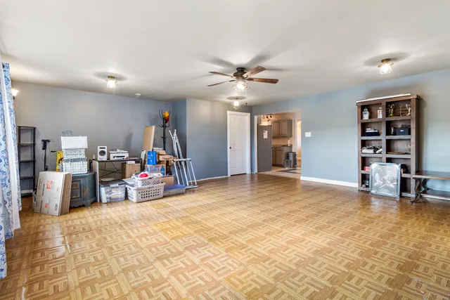 a view of a livingroom with workspace and a window