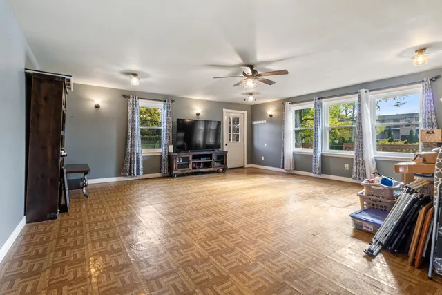 a view of a livingroom with furniture and a window