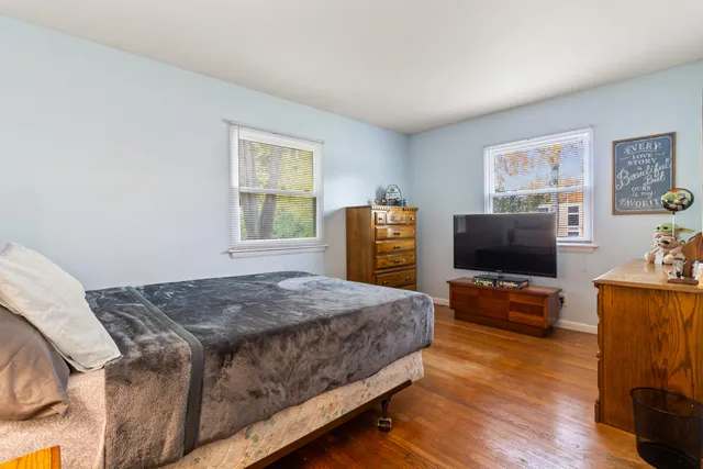 a bedroom with a bed and flat screen tv
