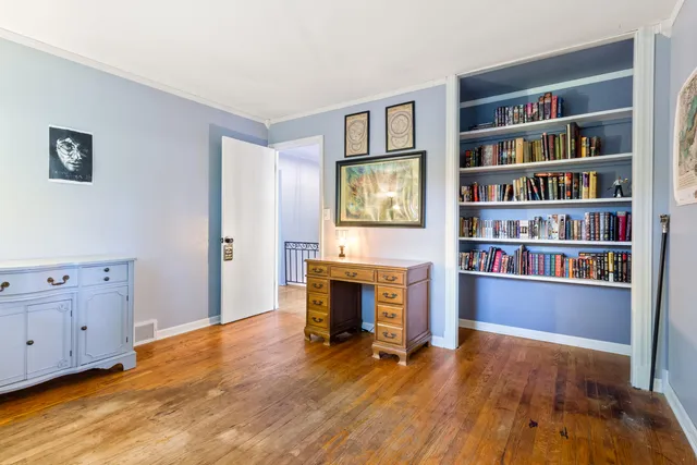 a view of an empty room with window and fireplace