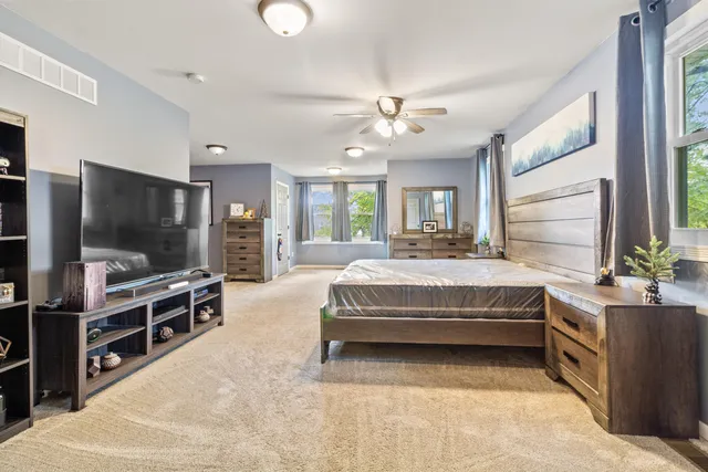 a living room with a bed and flat screen tv