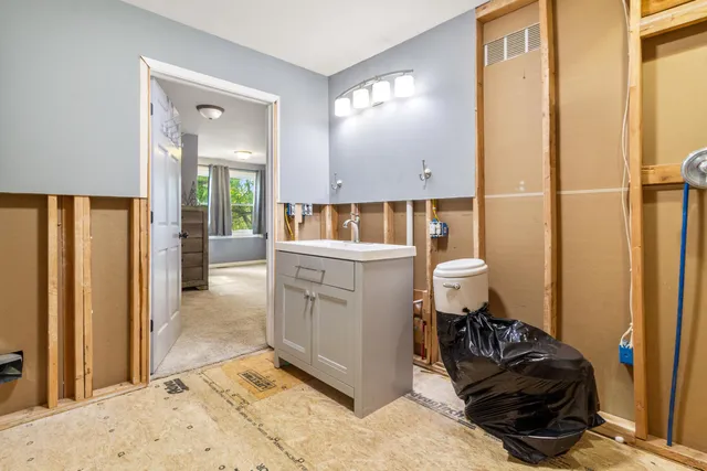 a room with furniture a mirror and a shower