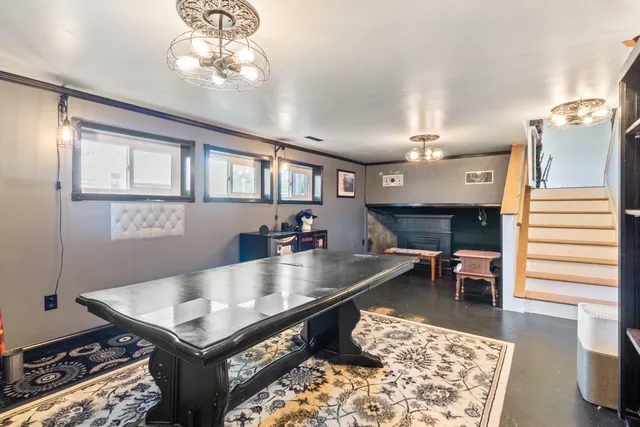 a living room with a table chairs and kitchen view