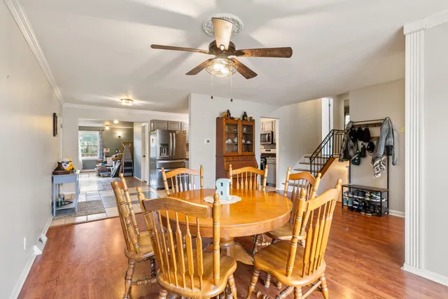a view of a dining room with furniture and wooden floor