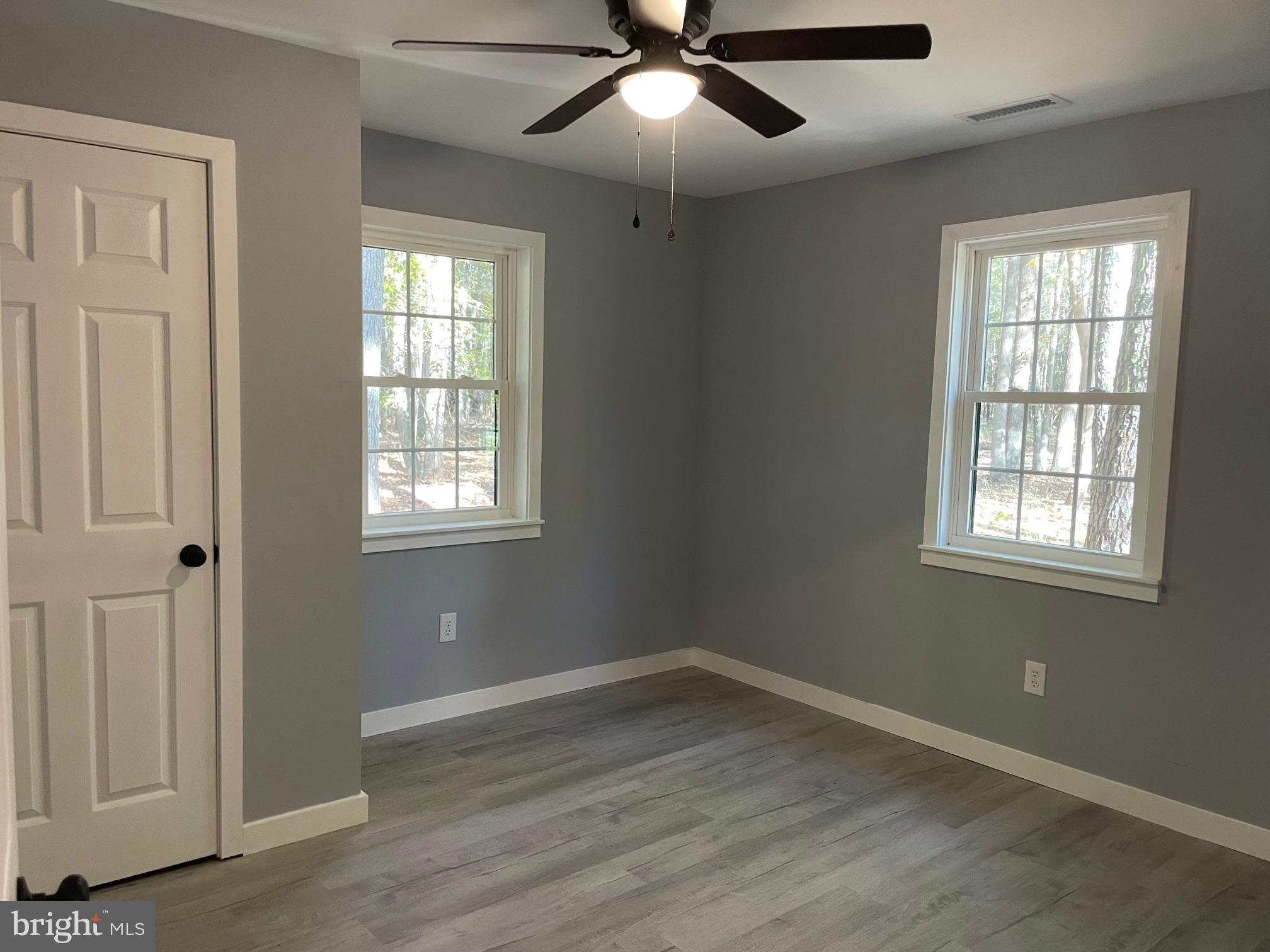 5051 Wayman Road Marion Station, MD 21838 - Photo 10 of 13 wooden floor in an empty room with a window