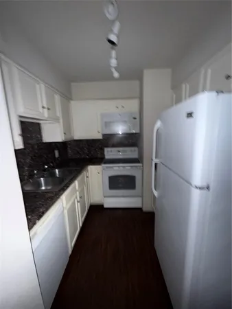 a kitchen with a refrigerator a sink and dishwasher