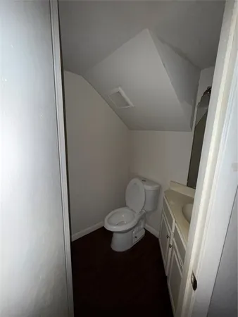 a bathroom with a toilet and a mirror