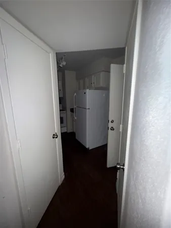 a view of a storage & utility room with a refrigerator