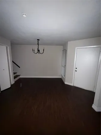 an empty room with wooden floor