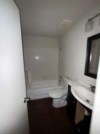 a bathroom with a sink a toilet and bathtub