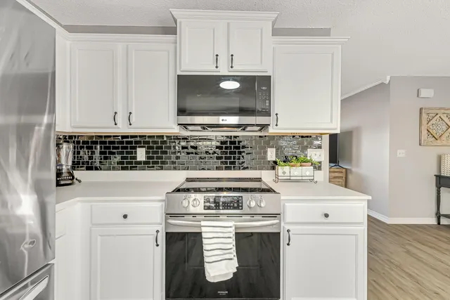 a kitchen with a stove and a microwave