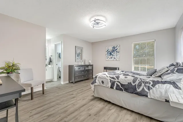 a bed room with furniture and a large window