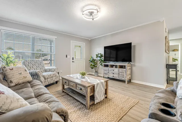 a living room with furniture and a flat screen tv