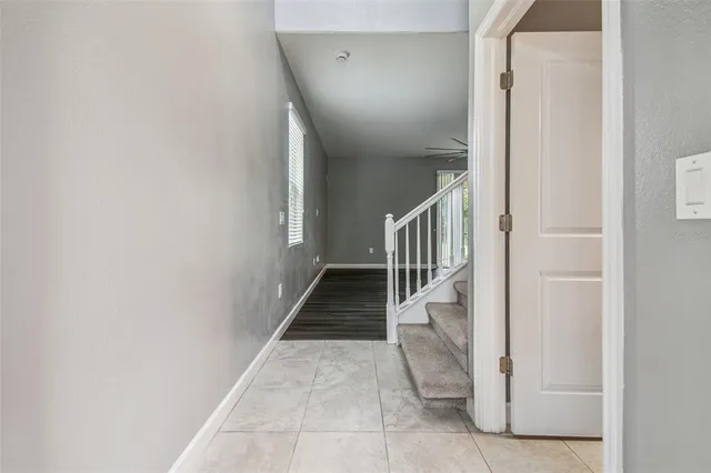 a view of a kitchen with a sink and dishwasher a refrigerator with wooden floor