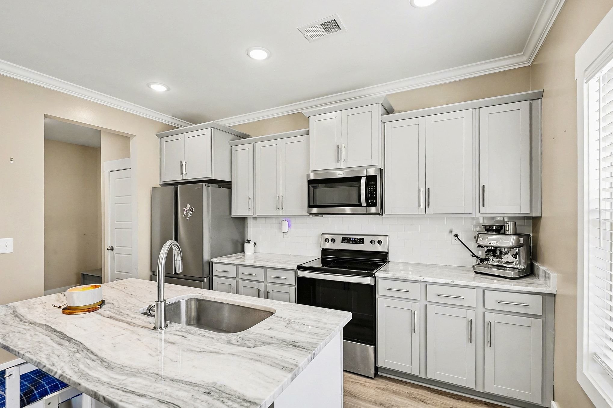 616 Bella Court Lebanon, TN 37087 - Photo 12 of 32 a kitchen with stainless steel appliances kitchen island granite countertop a sink and white cabinets